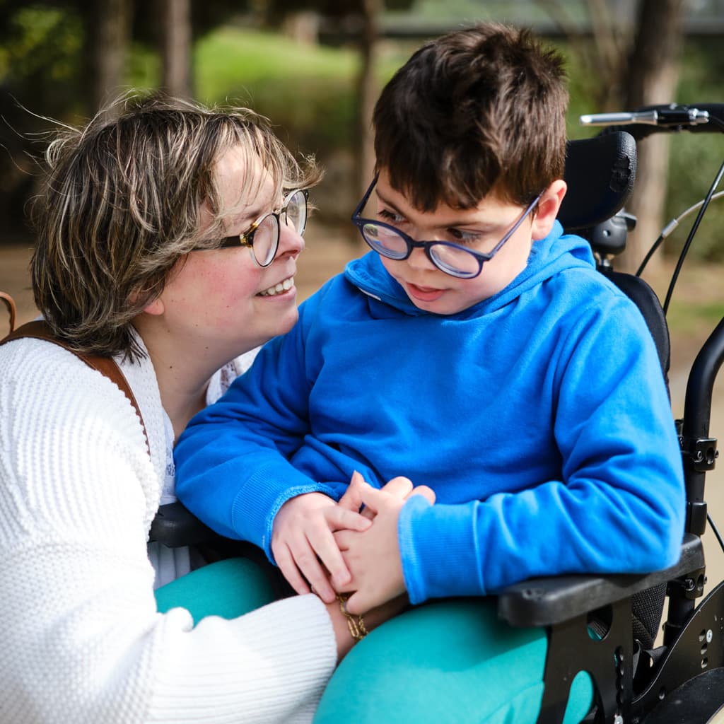A woman helping a young boy