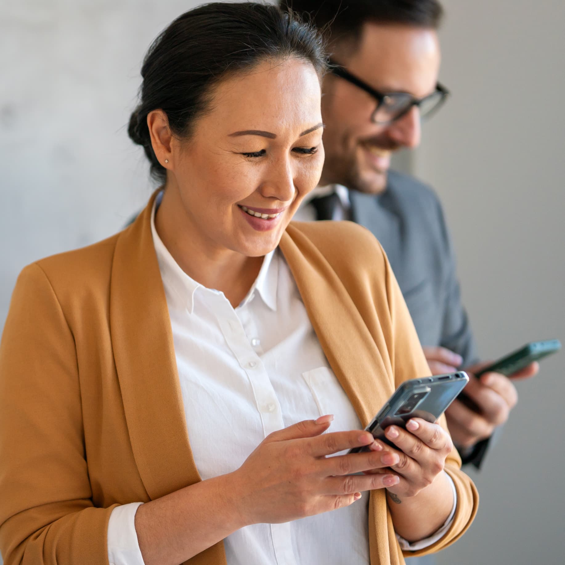 An Asian American woman looking at her cell phone
