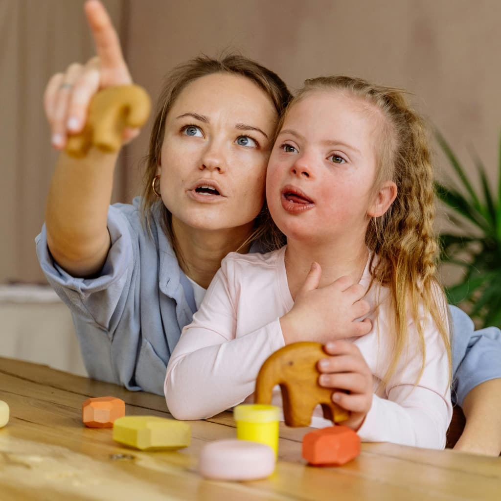 A woman teaching a young child