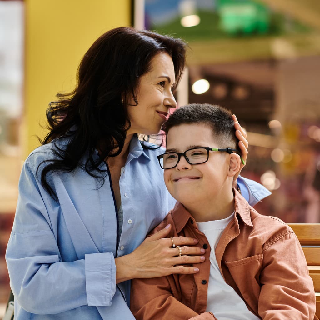 A woman hugging a child on a bench